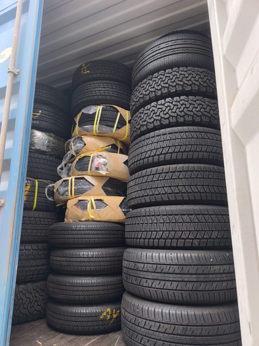 Mixed tires and wheel sets consolidated inside an export container in Japan